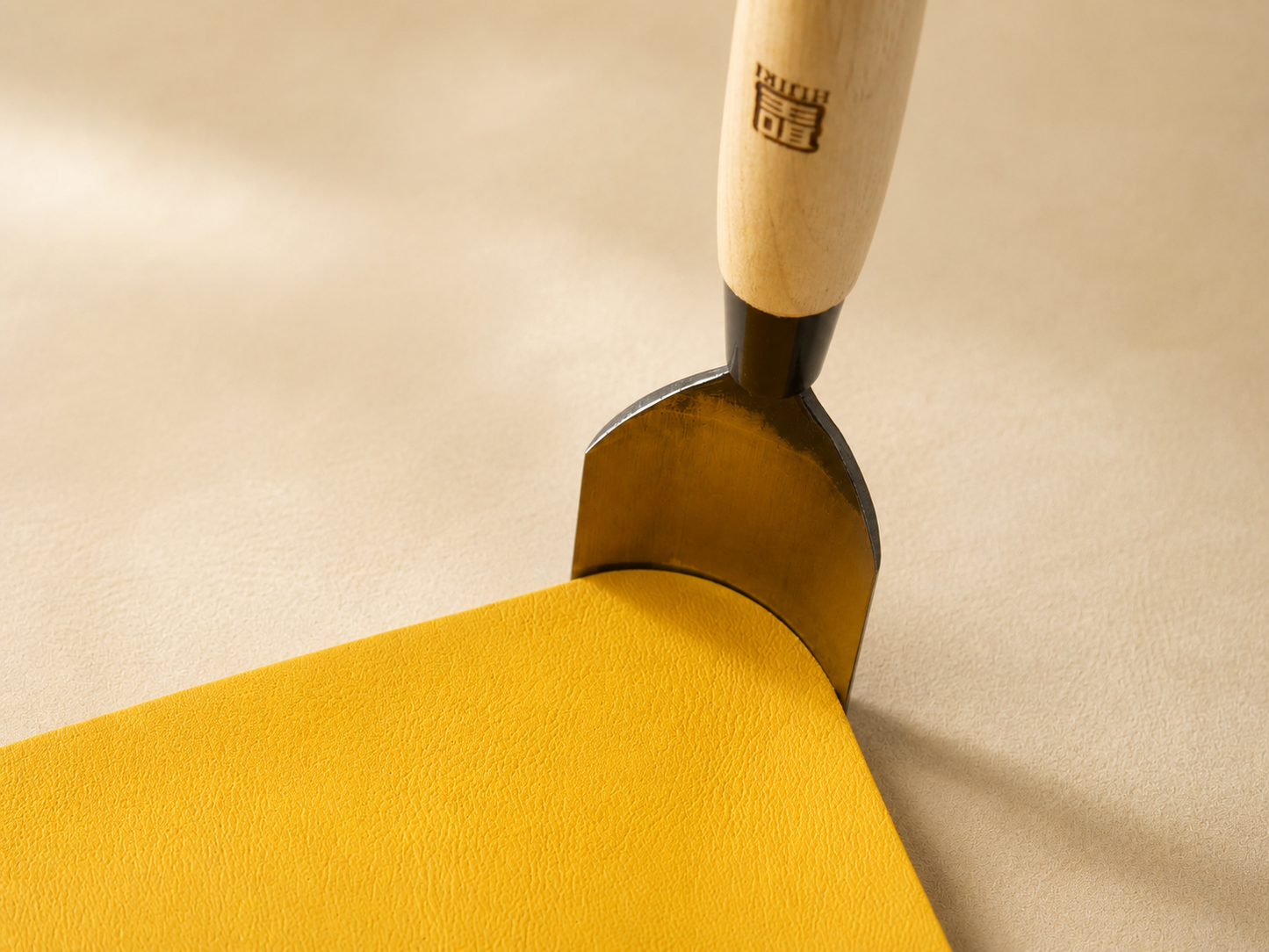 Cutting a rounded corner in leather by hand pressure