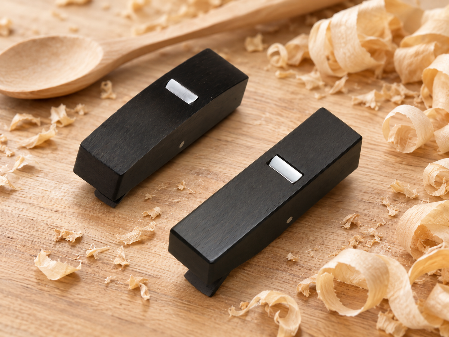 Both mini planes with wood shavings on a workbench